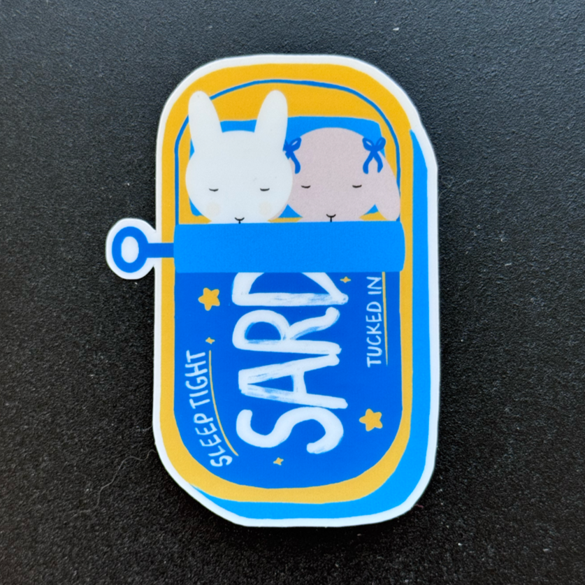 Sleepy Buns in their Sardine Tin Bed Sticker